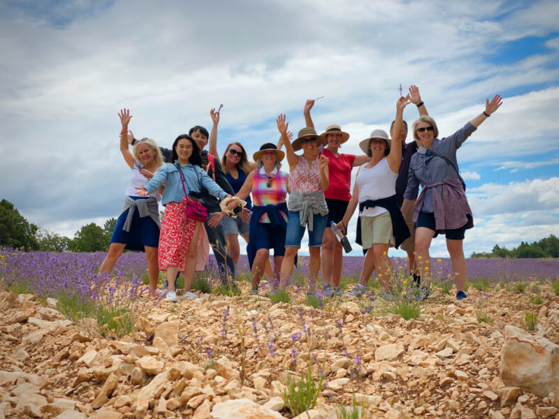 Provence lavender season tour guests frolicking in the lavender during France Off the Beaten Path Tour with Christy Destremau