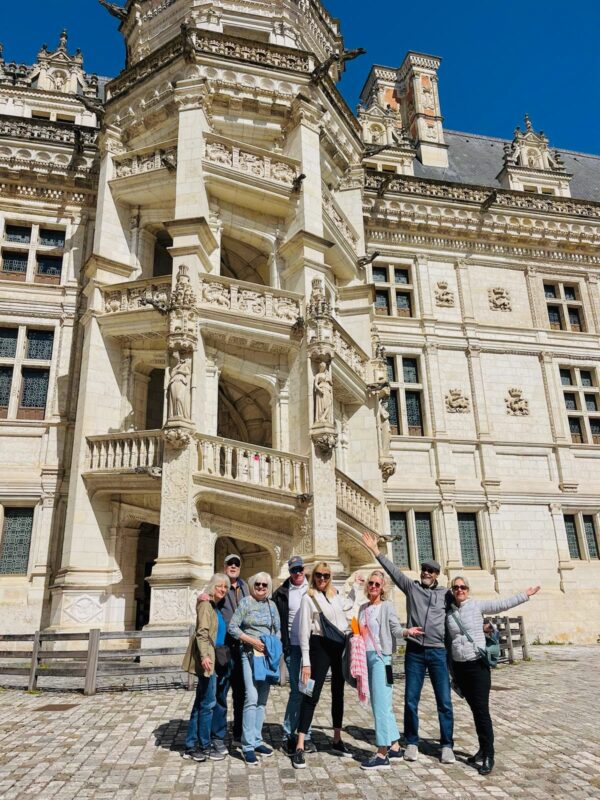 Spring tour guests inside the courtyard at Blois castle during France Off the Beaten Path Loire Valley tour itinerary.