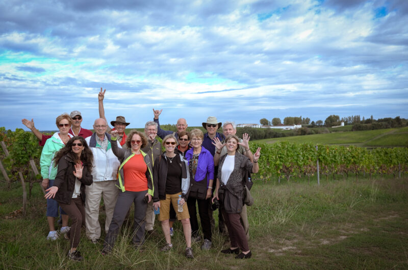 Tour guests during walk of Saint Emilio vineyards during France Off the Beaten Path Bordeaux Tour.